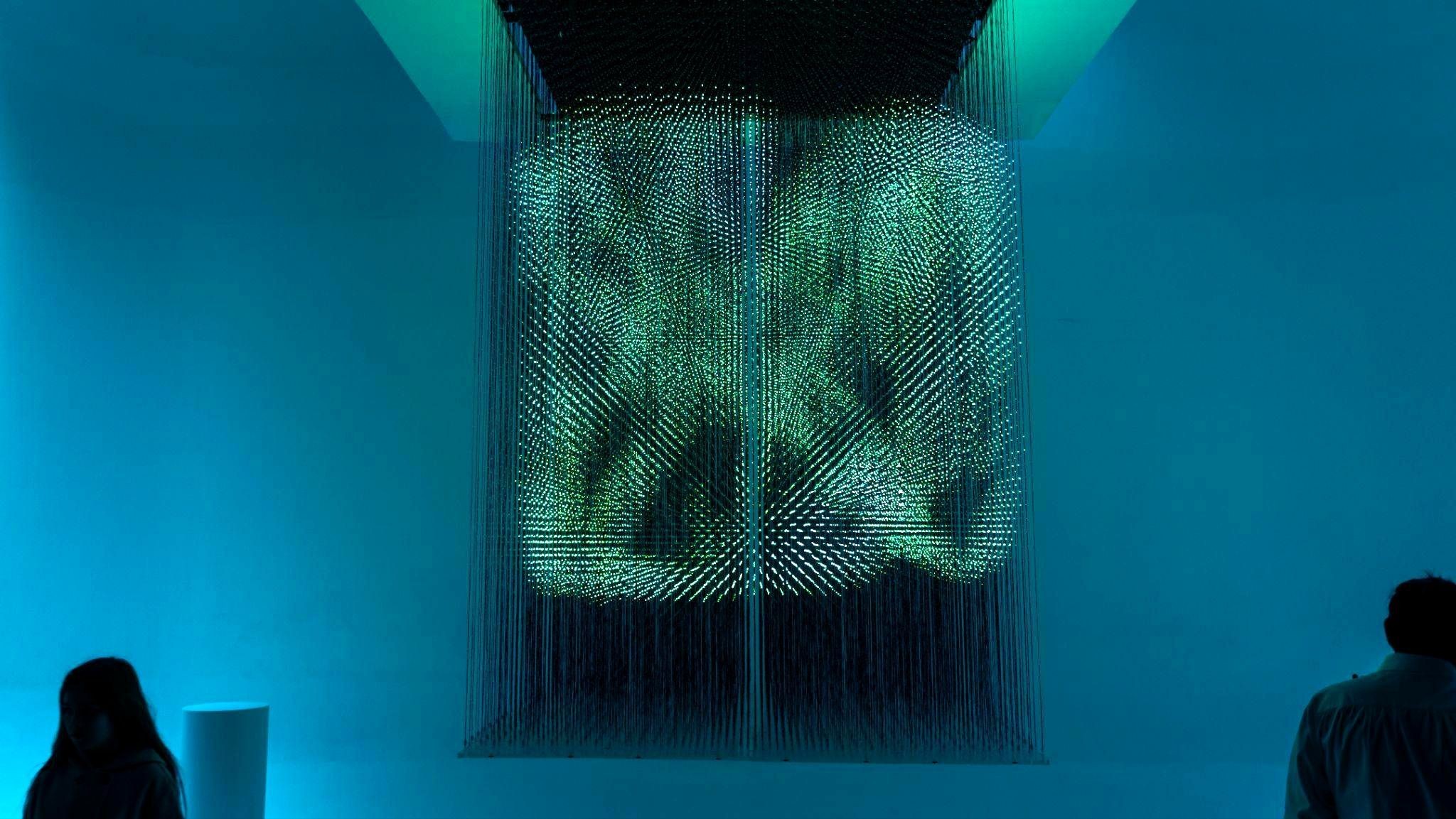 Audience member interacting with a LedPulse light installation